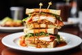 a clubhouse sandwich with plentiful sauces oozing out Royalty Free Stock Photo