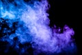 Clubs of colored smoke of blue and pink color on a black isolated background in the form of soft clouds Royalty Free Stock Photo