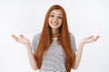 Clueless lovely tender redhead blue-eyed young girl smiling unaware shrugging hands spread sideways have no clue