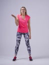 Clueless sport fit women trainer shrugging shoulders looking with confused look don`t understand