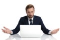 Clueless young businessman in navy blue suit reading emails Royalty Free Stock Photo