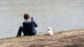 Young woman uses her smartphone at the river