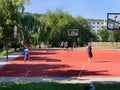 Teenagers playing basketball on playground
