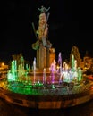 Multicolored illuminated fountain around the statue of Avram Iancu, located in Cluj-Napoca, Romania