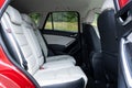 Rear view inside Mazda CX-5 SUV - white leather upholstery, passenger backseat