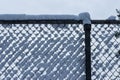 Clumps of fluffy white snow collected in a fence Royalty Free Stock Photo