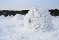 A clumsily constructed igloo, the traditional shelter of the northern peoples from the cold, made of snow bricks