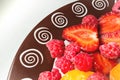 Cluse-up Fruit salad of apricots strawberries and raspberries on a plate. Top view