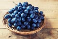 Cluster of Blue Grapes on Old Wooden Background.