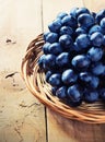 Cluster of Blue Grapes on Old Wooden Background.