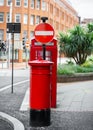 Cluster of bright royal red traditional old telephone box letter post box and no entry sign on beautiful summer day and no people. Royalty Free Stock Photo