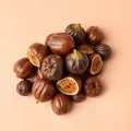 A cluster of dates and dried figs on a pastel peach background