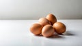 A cluster of five fresh brown eggs rests gently on a pristine white surface, illuminated by soft, diffused light. Generative AI Royalty Free Stock Photo