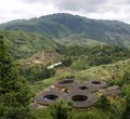 A cluster of Hakka Tulou homes overlooking the valley and mountain range in Yongding China