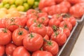 Cluster juicy tomatoes display at farmer market with price sign