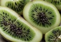 A cluster of kiwi fruit, cut open to reveal the emerald green flesh speckled with tiny black seeds.