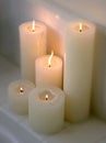 Cluster of lit candles on a ledge Royalty Free Stock Photo