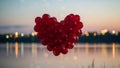 Heart-shaped balloon cluster at sunset Royalty Free Stock Photo