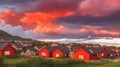 A cluster of red-roofed village houses under a dramatic evening sky.