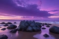 A cluster of rocks on a beach forming dark shapes against the colorful evening sky Royalty Free Stock Photo
