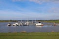 Cluster of sailboats moored in a peaceful harbor in East Frisia, Germany Royalty Free Stock Photo