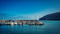 Cluster of small boats docked against a picturesque rocky shoreline in Madeira, Portugal