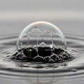 A cluster of soap bubbles floats on a water surface creating ripples around Royalty Free Stock Photo