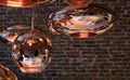 Cluster of Tom Dixon metallic pendant lights hanging in the Tom Dixon flagship store and showroom at Coal Drops Yard, Kings Cross. Royalty Free Stock Photo