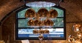 Cluster of Tom Dixon metallic pendant lights hanging in the Tom Dixon flagship store and showroom at Coal Drops Yard, Kings Cross.