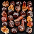 Clusters of red and orange garnet crystals are displayed on a dark surface. The Royalty Free Stock Photo