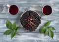 Clusters with ripe elderberry berries and mugs of drink