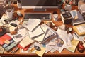 A cluttered desk with papers, documents, and gadgets, illustrating a busy workspace and the challenges of staying organized. Royalty Free Stock Photo