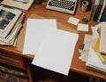 A Cluttered Desk Setup Featuring Blank Pages Amidst Various Office Supplies and Old Documents Waiting for Creativity Royalty Free Stock Photo