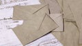 Cluttered Mail Delivery: Scattered Brown Kraft Envelopes on a Rustic Painted Table Royalty Free Stock Photo