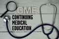 CME Continuing Medical Education text with Stethoscope on wooden background Royalty Free Stock Photo