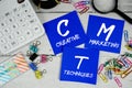 CMT Creative Marketing Techniques text on paper notes with calculator, alarm clock and magnifying glass Royalty Free Stock Photo