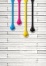 Cmyk ink drops on white wooden background Royalty Free Stock Photo