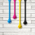 Cmyk ink drops on white wooden square background Royalty Free Stock Photo