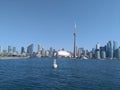 The CN tower stands in the blue sky