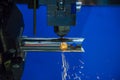 The CNC fiber laser cutting machine cutting the stainless tube with the sparking light.