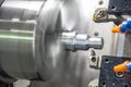 The CNC lathe cutting the thread at the metal parts.