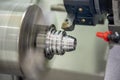 The CNC lathe machine cutting the groove