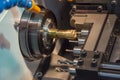 The CNC lathe or turning machine making the hole at the brass s