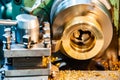 A cnc lathe worker makes a round piece of bronze