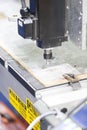 CNC machine cutting acrylic plate