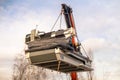 Cnc machine hanging on hook crane.