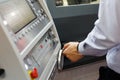 CNC machine operator making adjustments