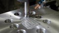 CNC machine is whittling hole in a metal detail in a plant, cutting machine tool is working, close-up