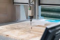 Cnc machine at work process cutting wood with drill, close up