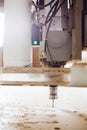 Cnc machine working, cutting wood. Woodwork industry. Royalty Free Stock Photo